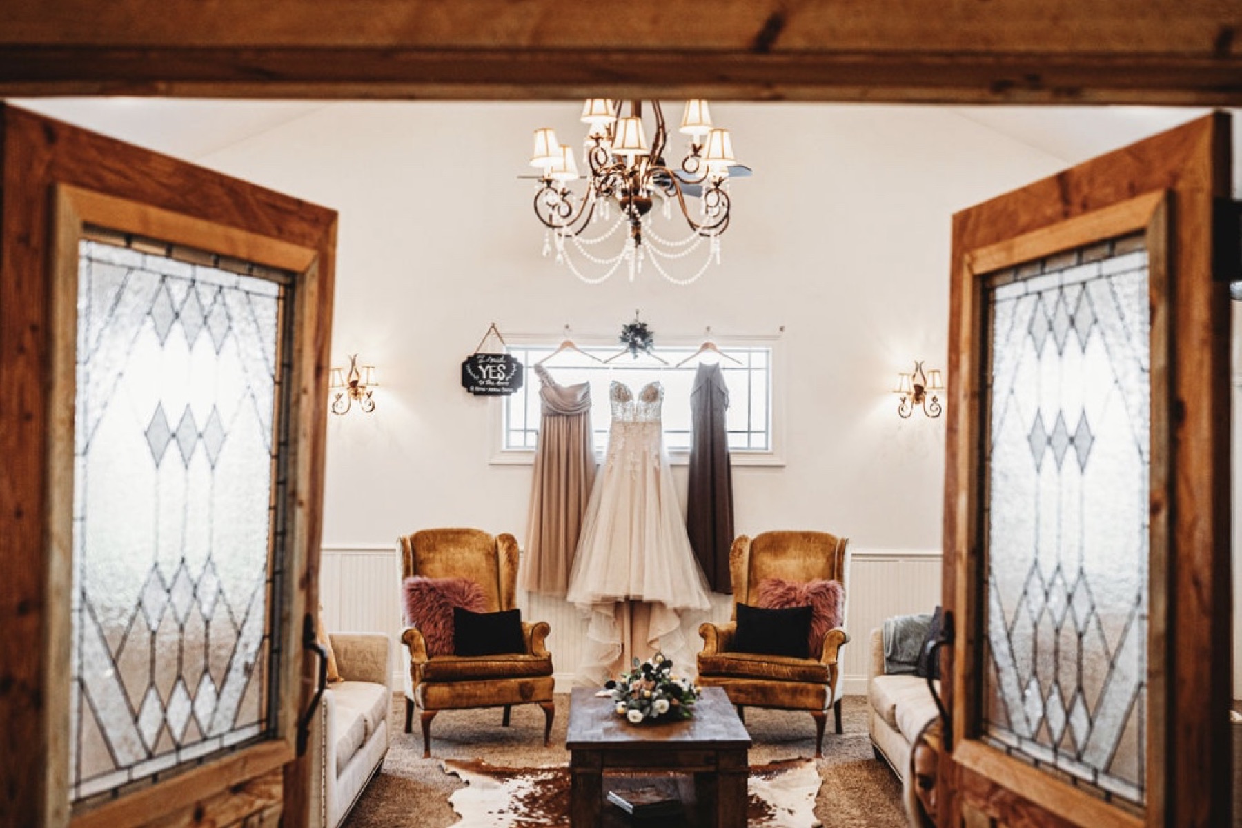 Inside the cedar barn at Diamond H3 Ranch with tin cathedral ceilings and chandeliers